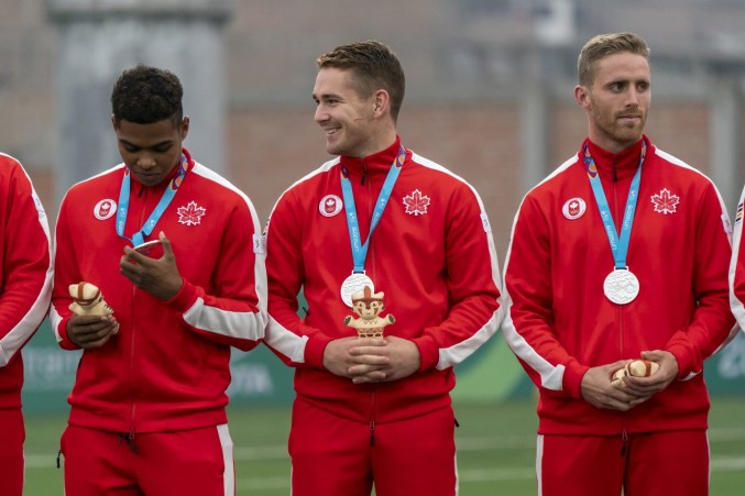 Image of Team Canada's rugby men on the Lima podium.