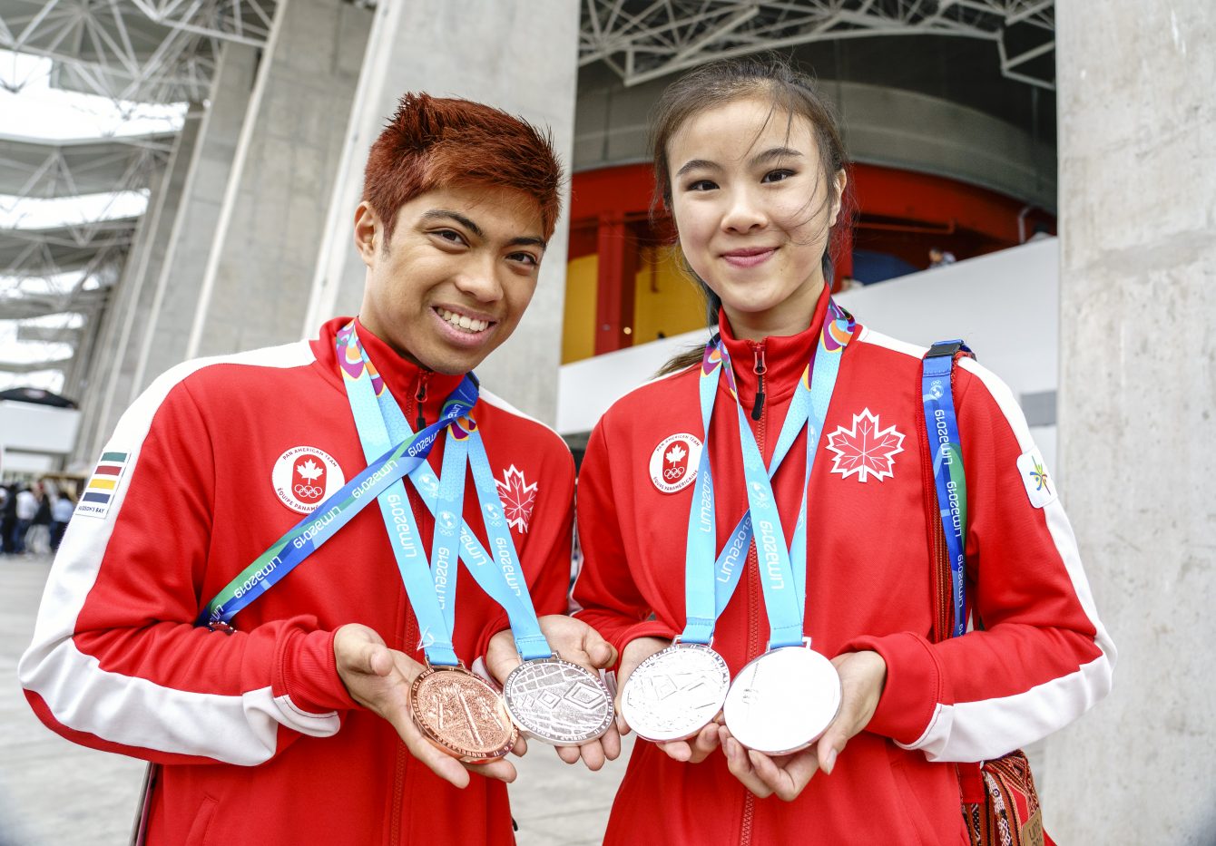 AJ Assadian (left) and Michelle Lee, pose for photos with their medals at Lima 2019.