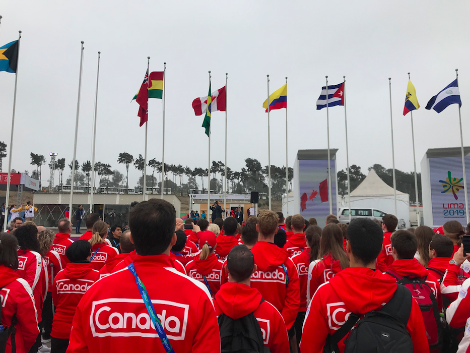 Athletes watching the flags raise