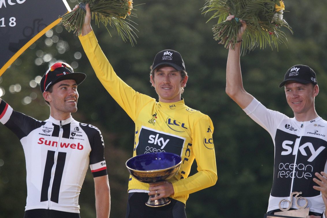 Tour de France winner Britain's Geraint Thomas, wearing the overall leader's yellow jersey, celebrates on the podium