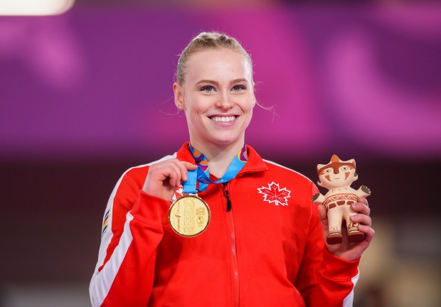 Ellie Poses with her gold at Lima