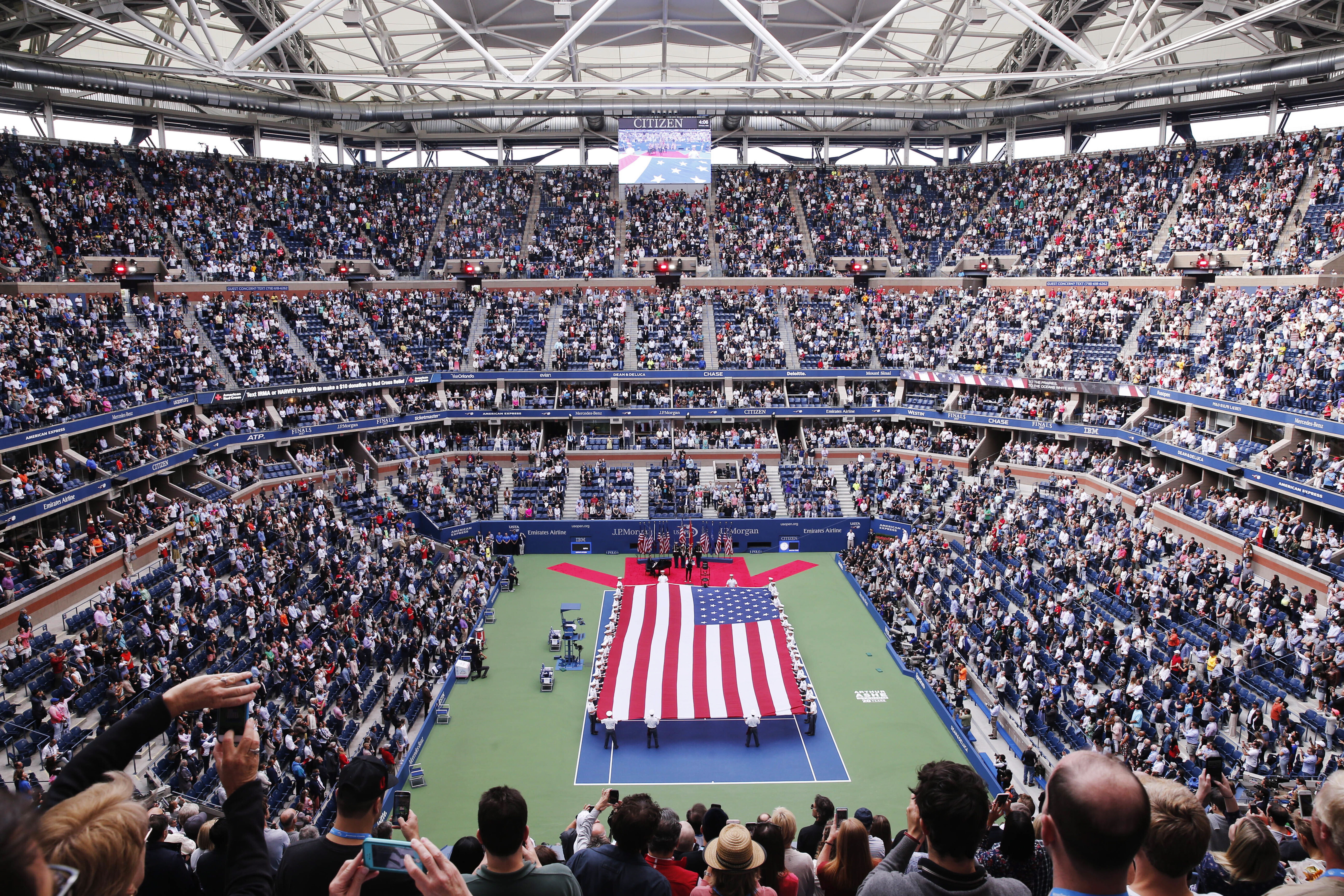 Aerial view of a tennis stadium with big USA flag