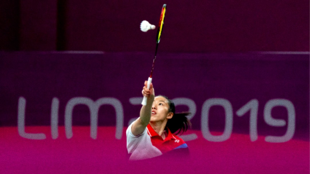 Badminton player hitting shuttlecock