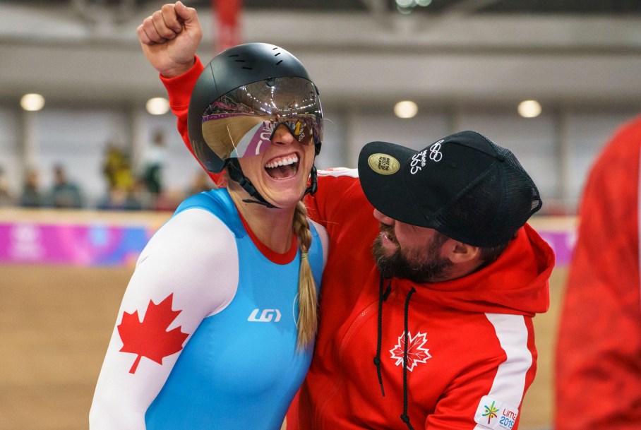 Kelsey Mitchell celebrates with her coach after winning the gold