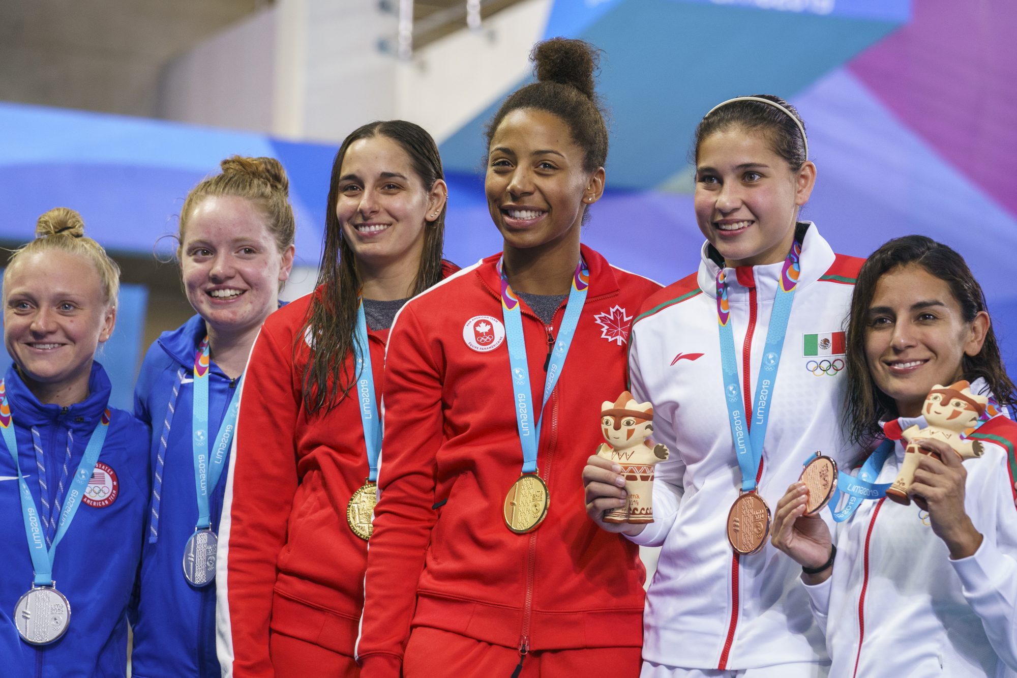 six divers on the podium with medals
