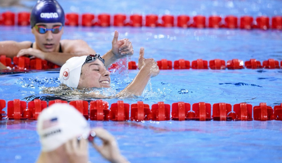 swimmer gives thumbs up in the water