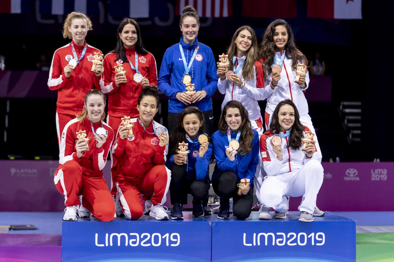 Women's foil team poses with silver medals