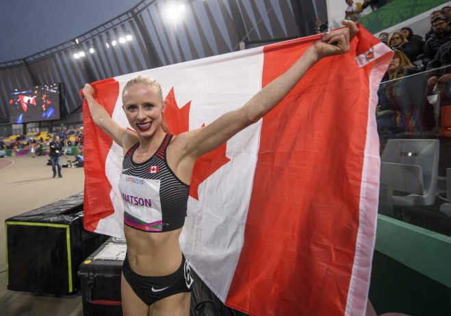 Sage Watson holding the Canadian flag after winning Lima 2019 gold