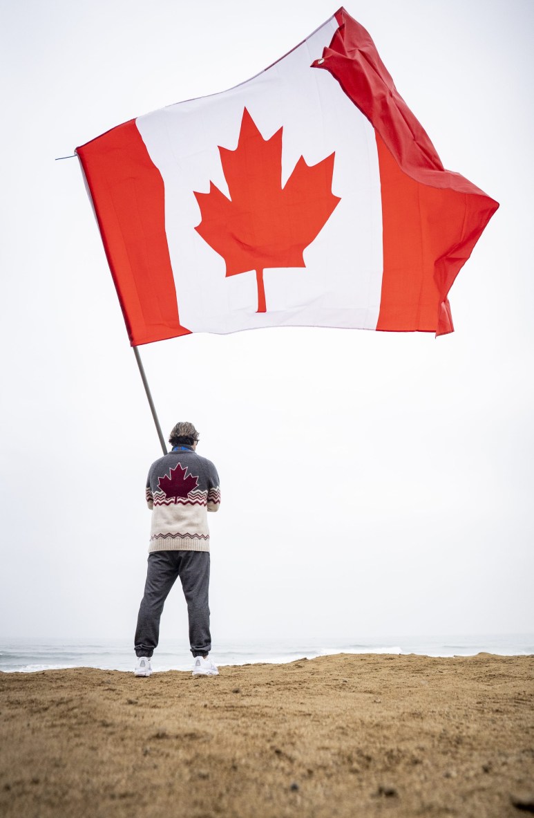 person holds a large canadian flag