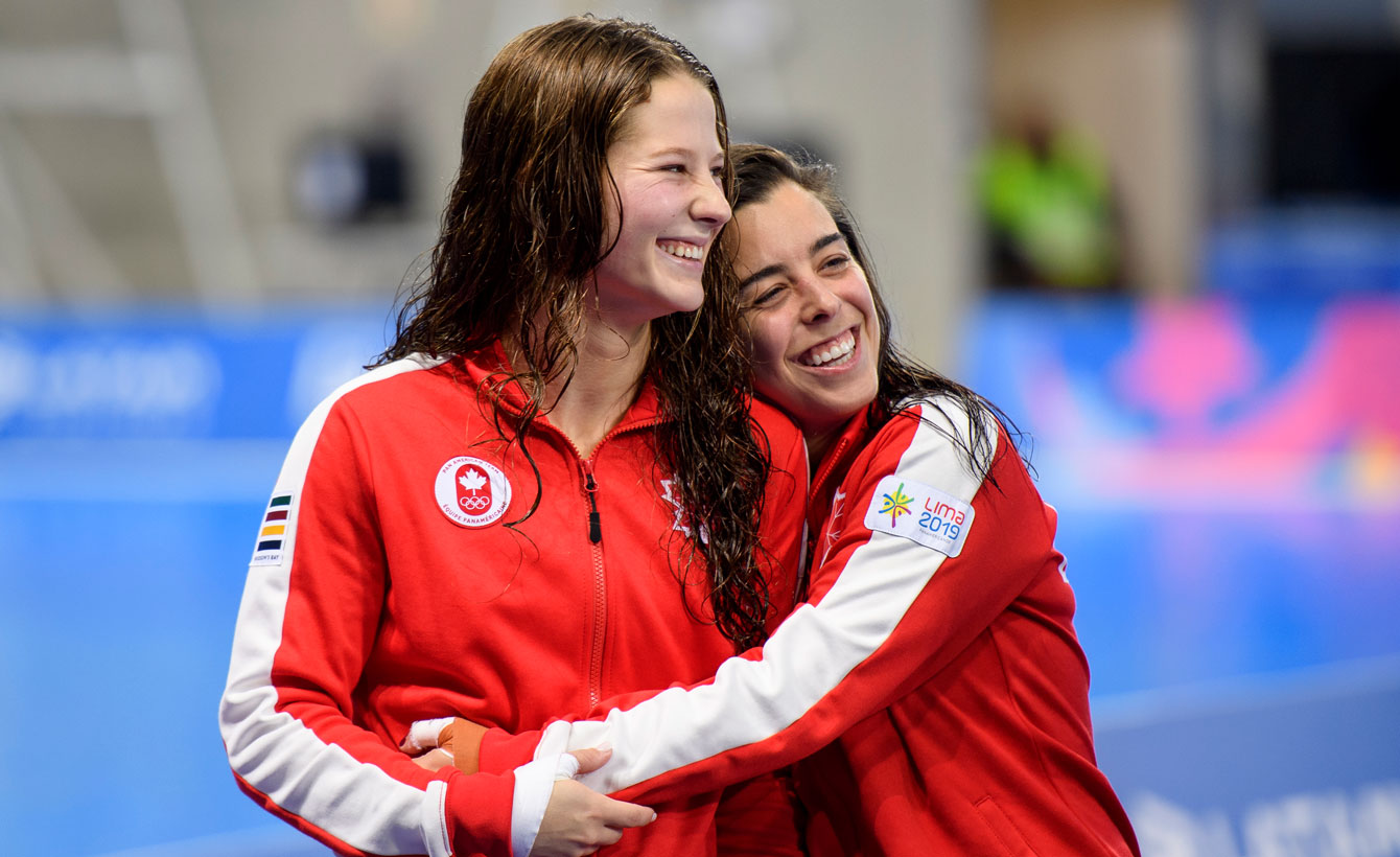 Meaghan hugs Caeli after their gold medal at Lima 2019.