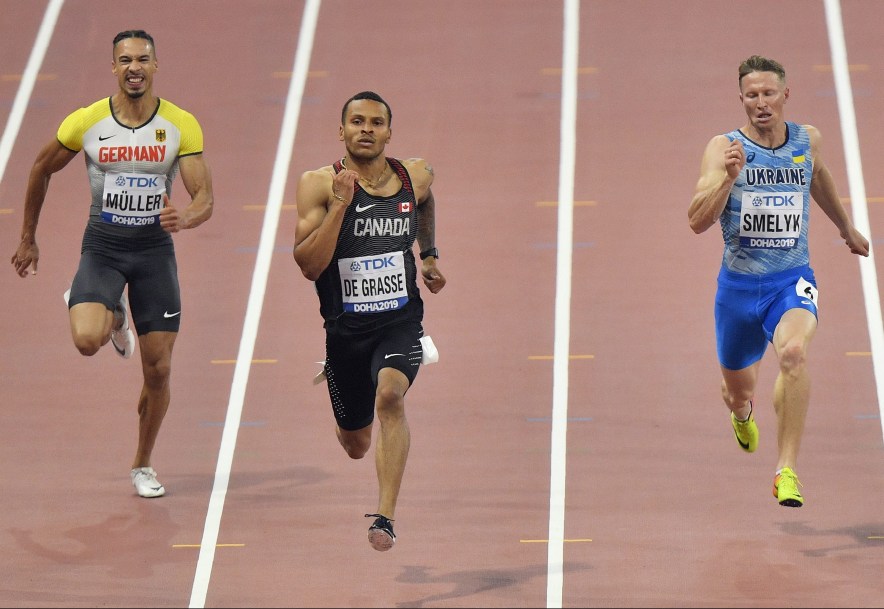 Steven Müller, of Germany, Andre De Grasse, of Canada, and Serhiy Smelyk, of Ukraine, from left to right, compete in the men's 200 meter
