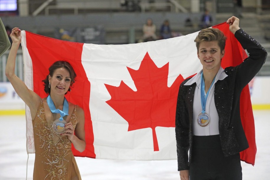 Third-place finishers Carolane Soucisse and Shane Firus, of Canada, celebrate following the free dance competition