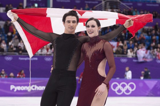 Ice dance gold medallists Canada's Tessa Virtue and Scott Moir skate with the Canadian flag