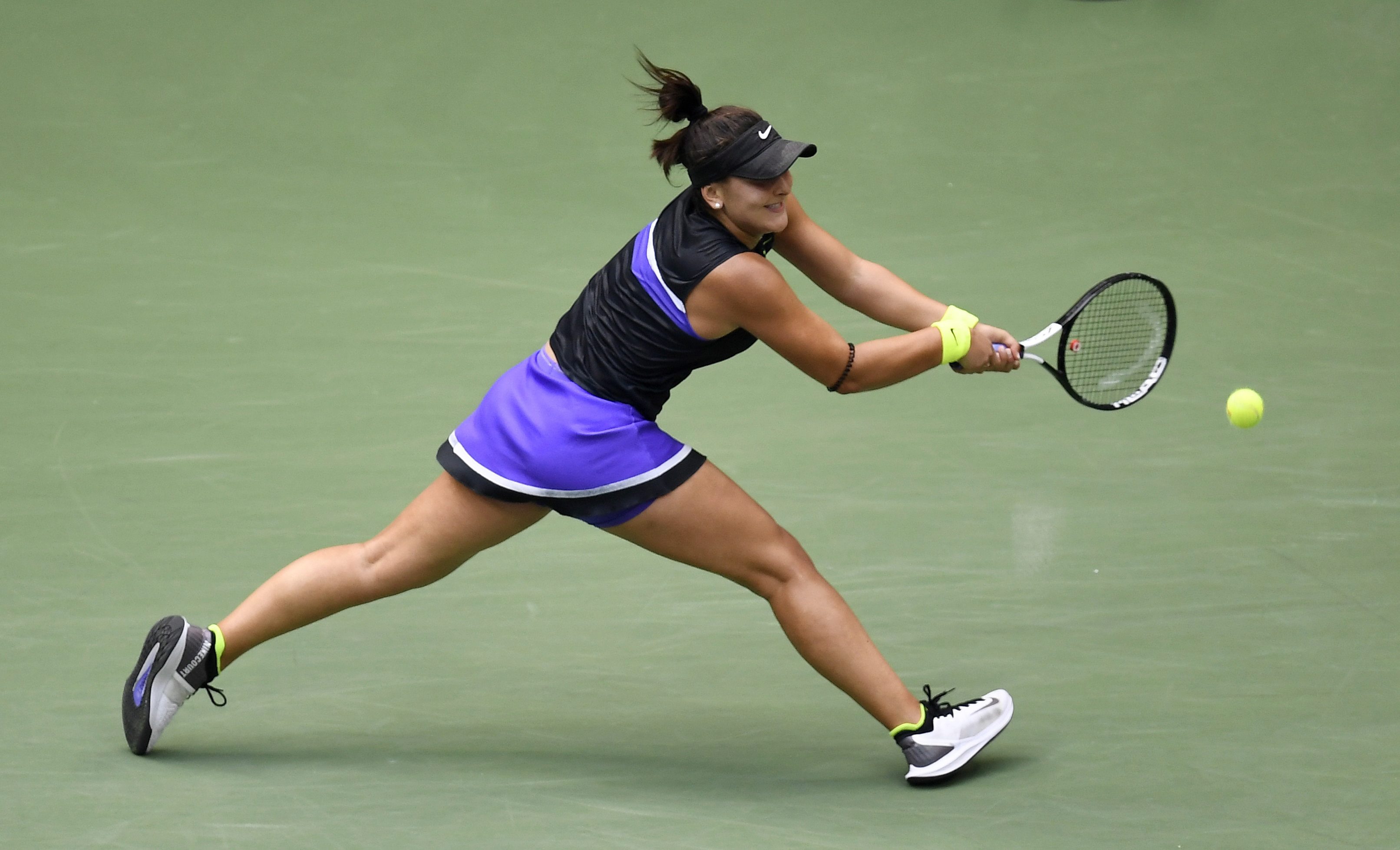 Bianca Andreescu gets her ready to return a shot via backhand. 