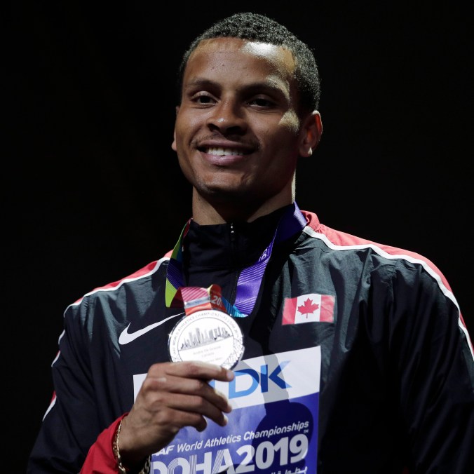 Qatar Athletics Worlds Andre de Grasse holding silver medal