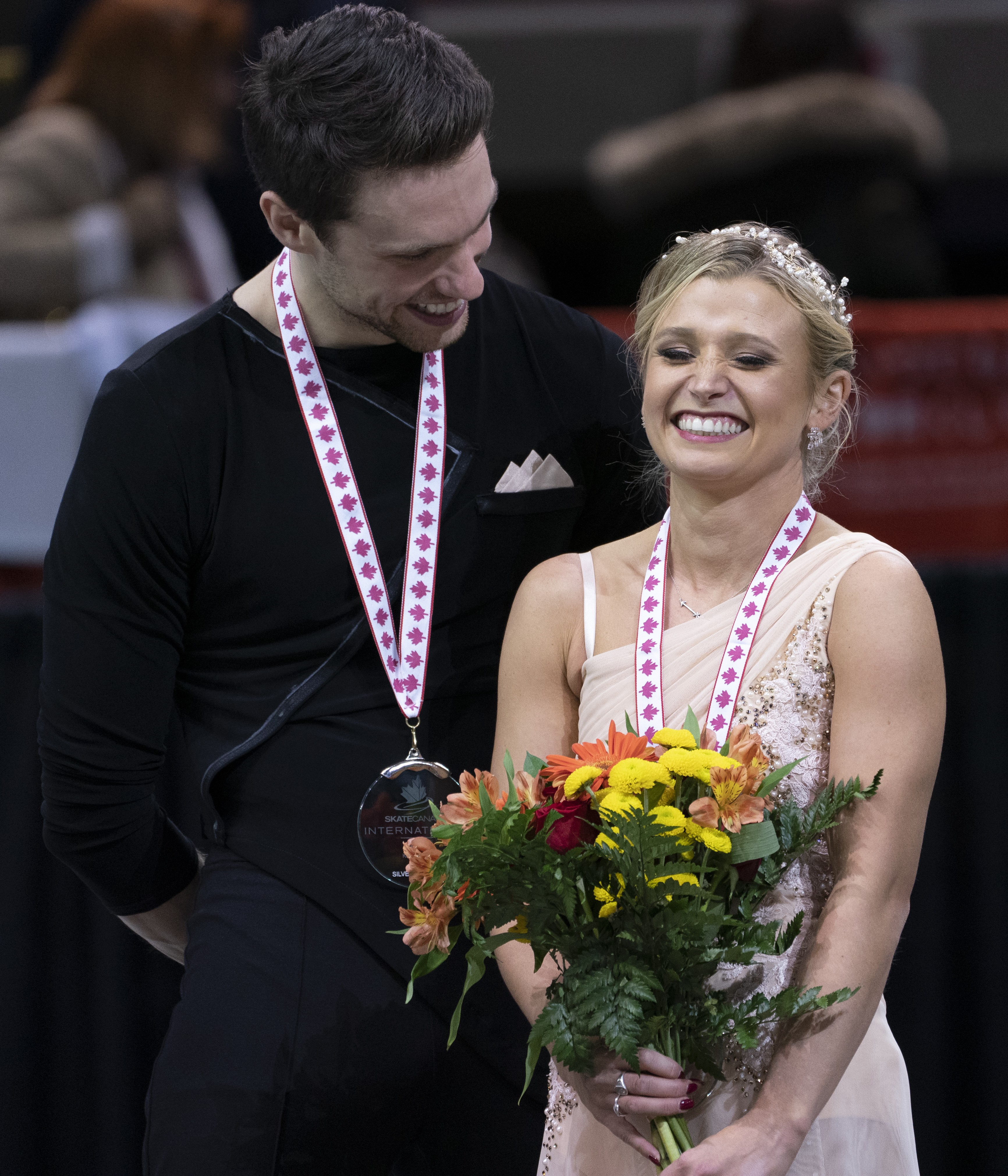 Kirsten Moore-Towers and Michael Marinaro share a laugh during victory ceremonies