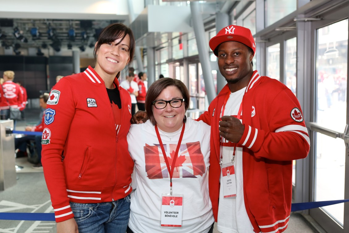 A volunteer and athletes at London 2012 Canada Olympic House.