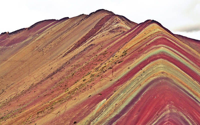 Mountains adorned with red, yellow, and green colours.