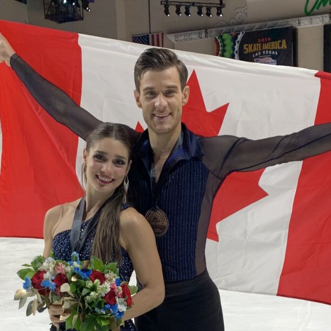 Laurence Fournier Beaudry (front) poses with Nikolaj Sørensen, who is holding the Canadian flag up behind him.