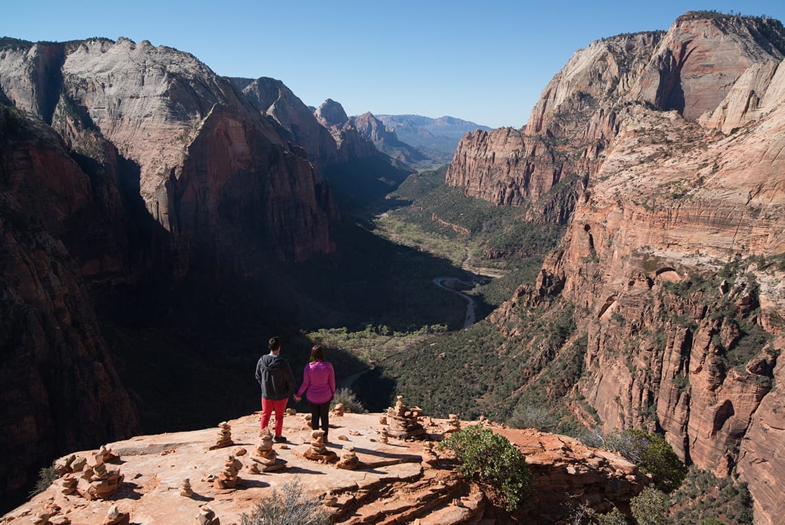 Two hikers overlook Zion's Canyon.