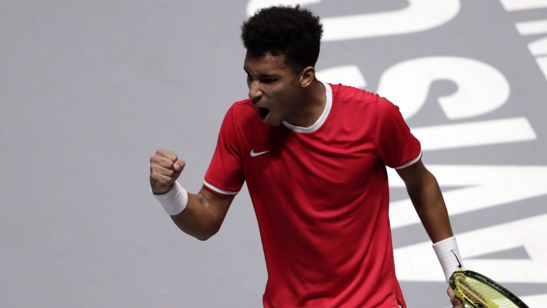 Felix Auger-Aliassime pumps his fist and yells
