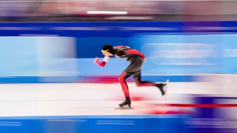 An artistically blurry photo of a speed skater whizzing by