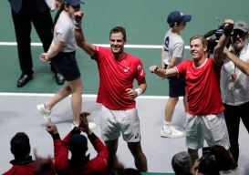 Denis Shapovalov, right, and his partner Vasek Pospisil celebrate after winning their Davis Cup semifinal doubles match