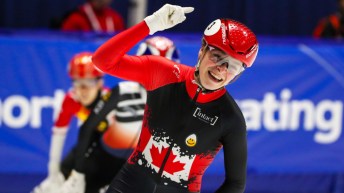 Kim Boutin celebrates as she passes the 1000m finish line at the ISU Short Track World Cup in Montreal