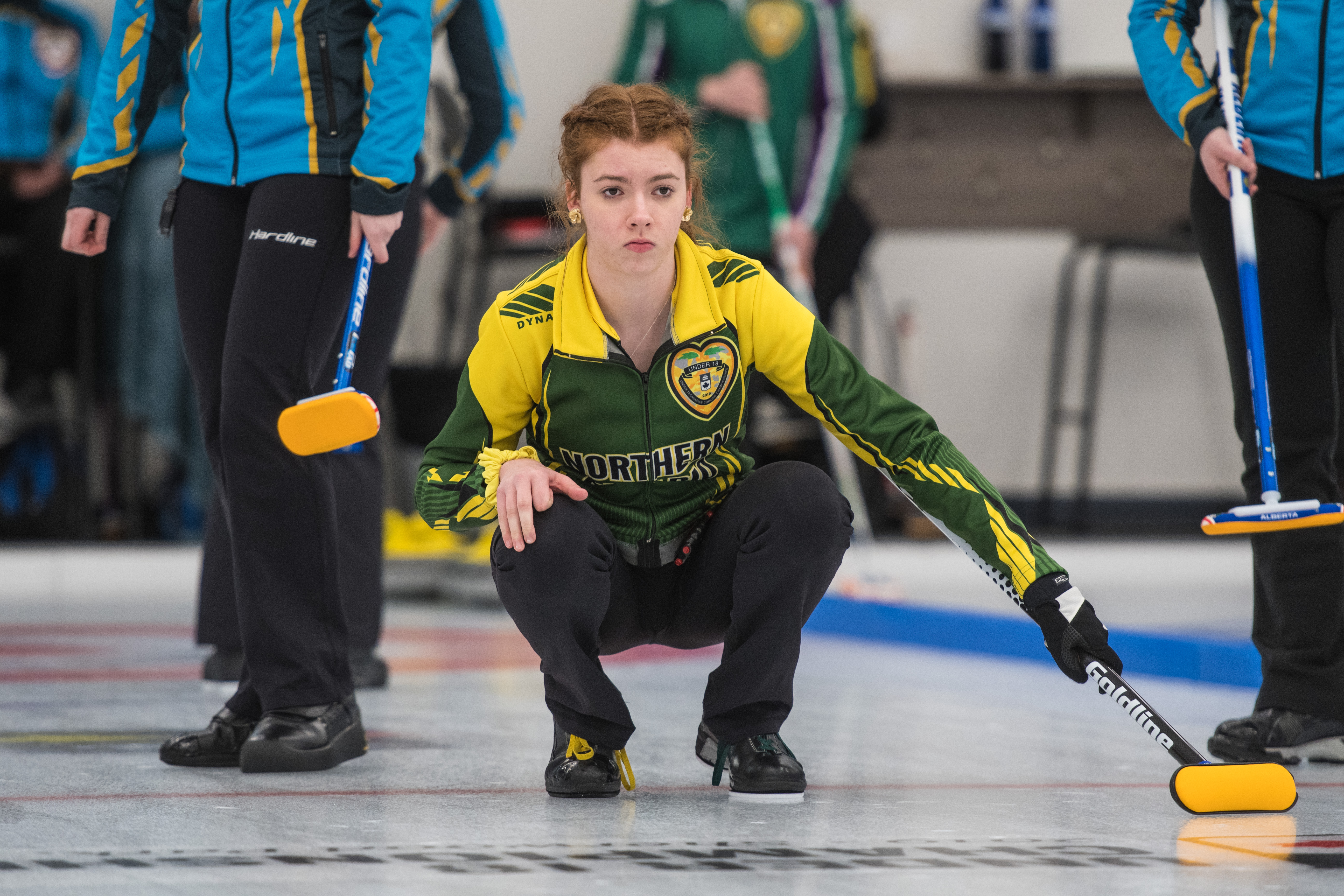 Lauren Rajala crouching down, watching.