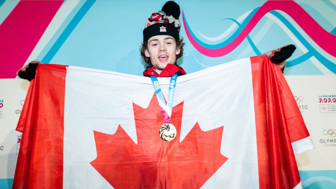 Andrew Longino poses with the Canadian flag