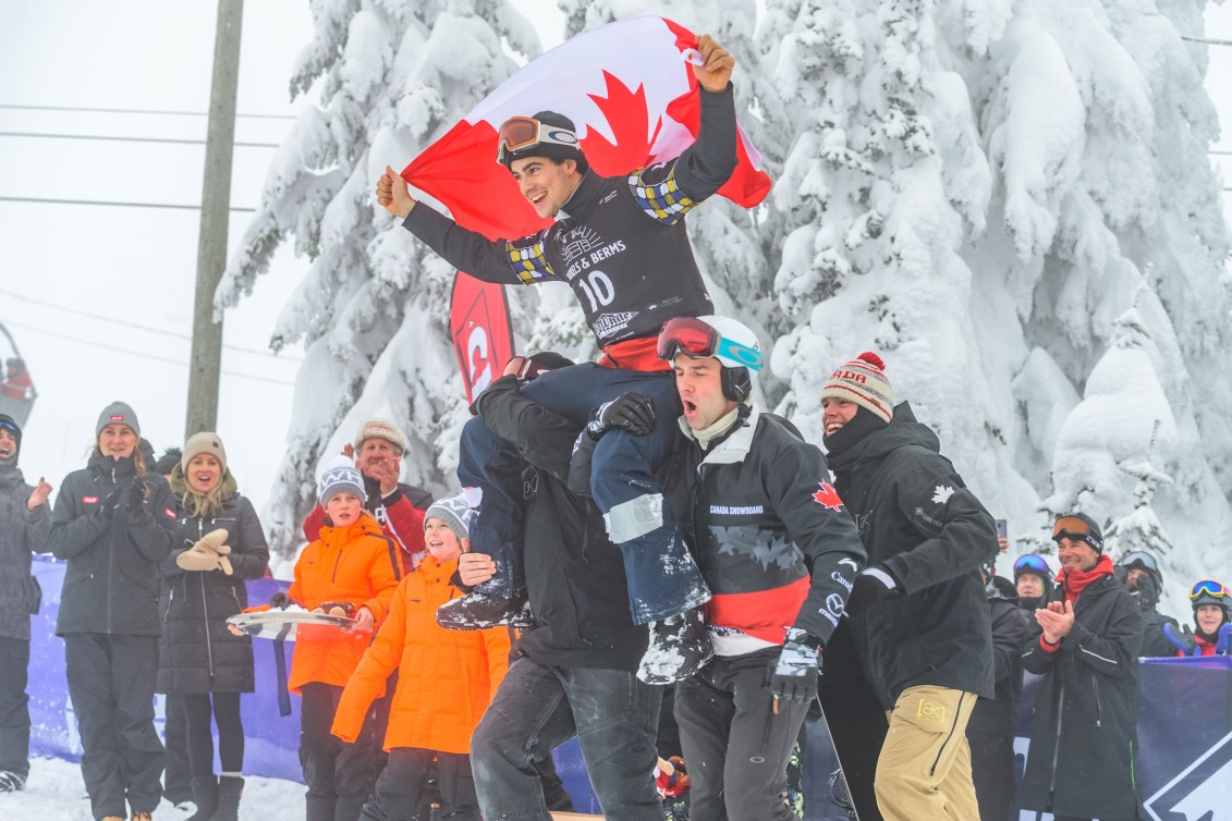 Eliot's teammates carry him to the podium on their shoulders