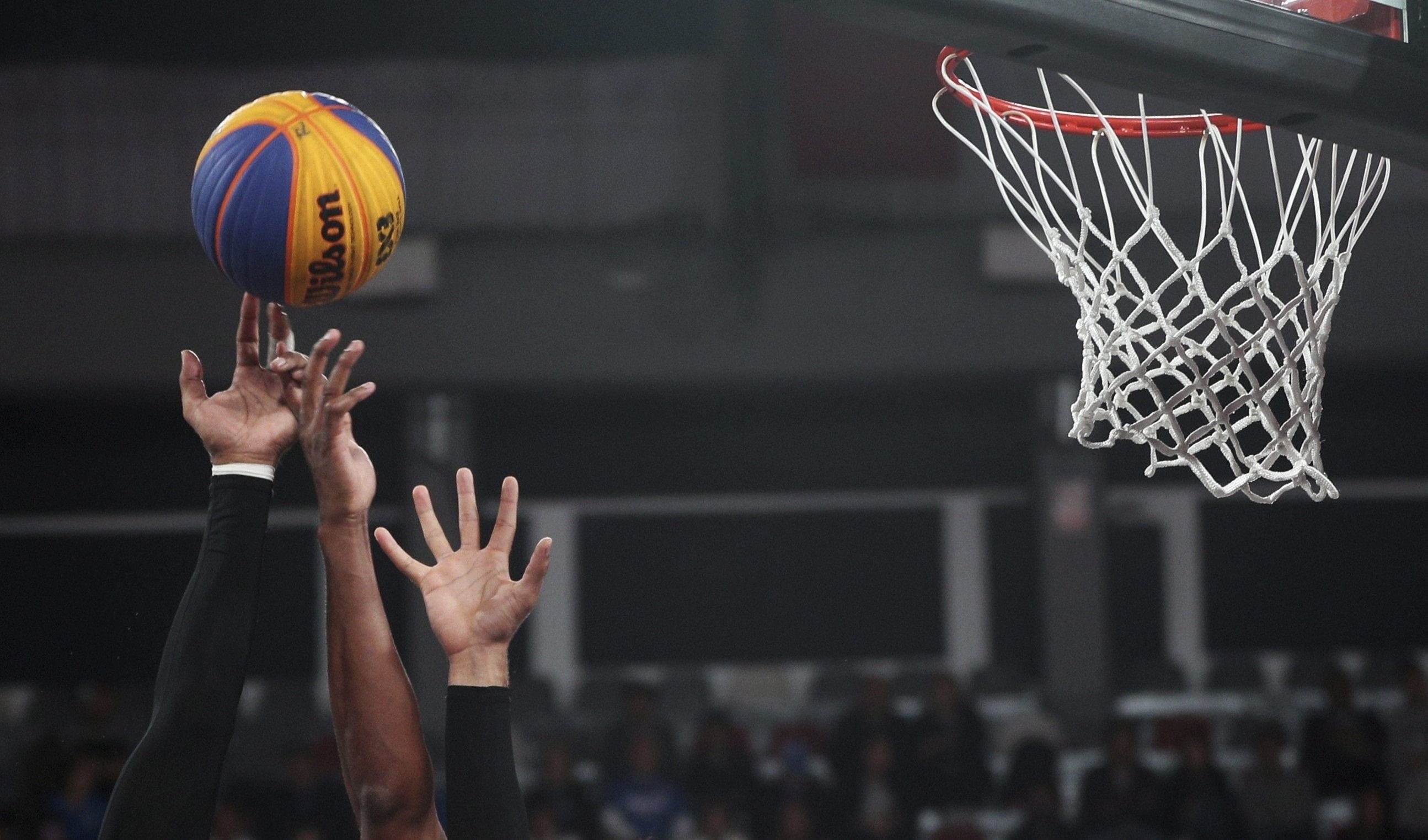 Teammates double up to block a shot during the men's basketball 3x3 semi-final match at the Pan American Games in Lima, Peru, 