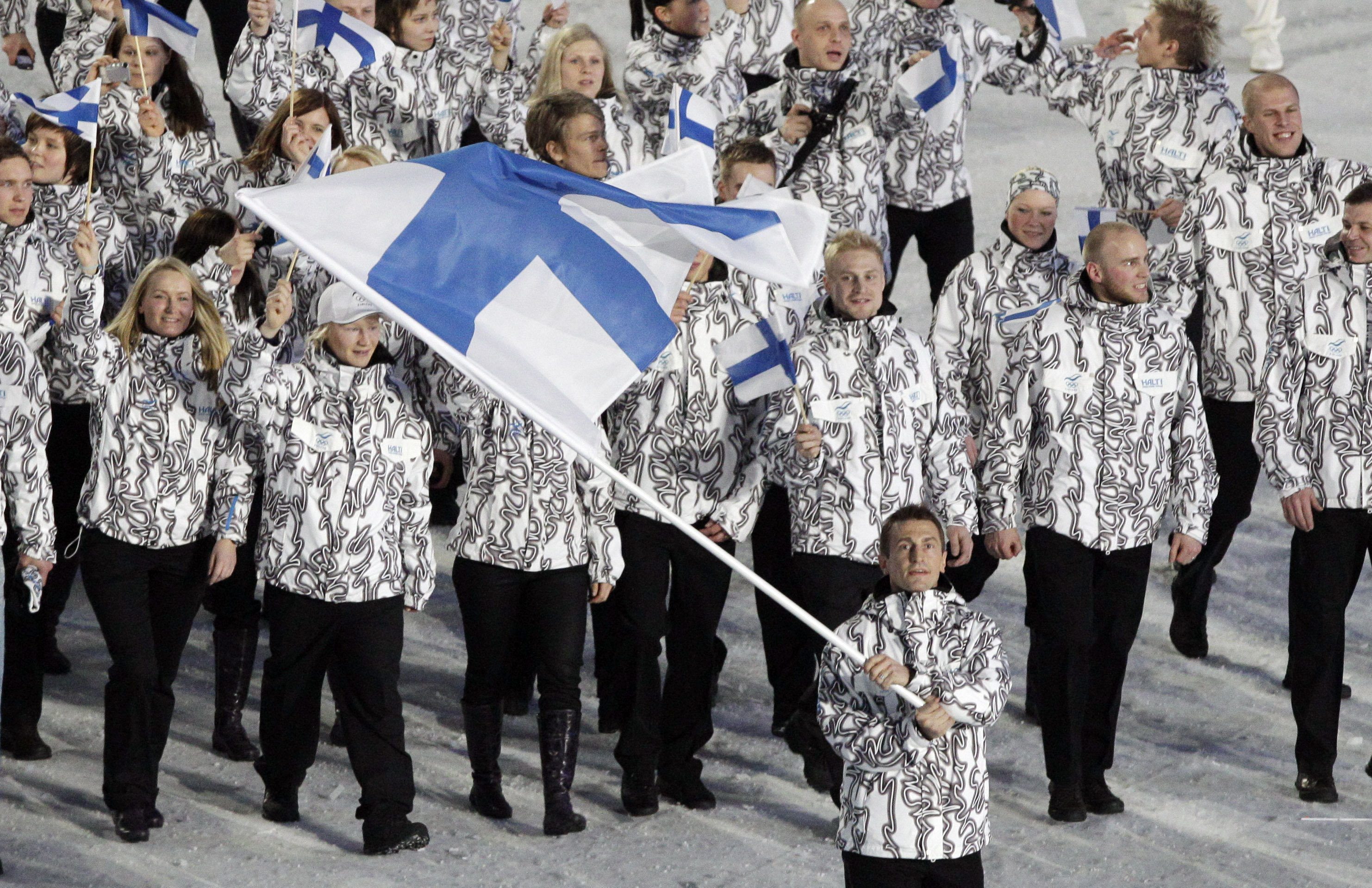 Finland's Ville Peltonen carries the flag during the opening ceremony for the Vancouver 2010 Olympics in Vancouver, British Columbia, Friday, Feb. 12, 2010.