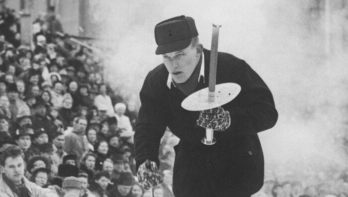A man carries the Olympic torch during the 1952 Oslo Olympic torch relay