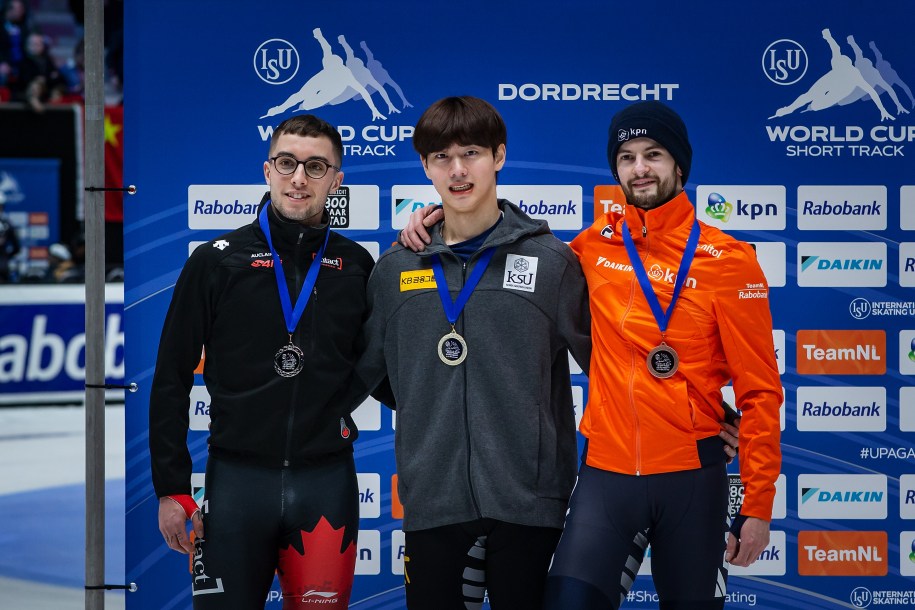 Short track speed skating medallists stand on the podium after competing