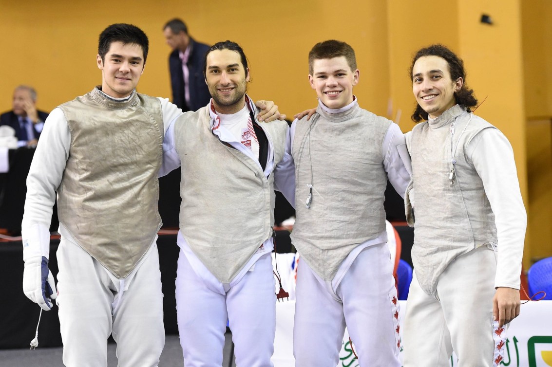 The men's team foil team poses for a group photo