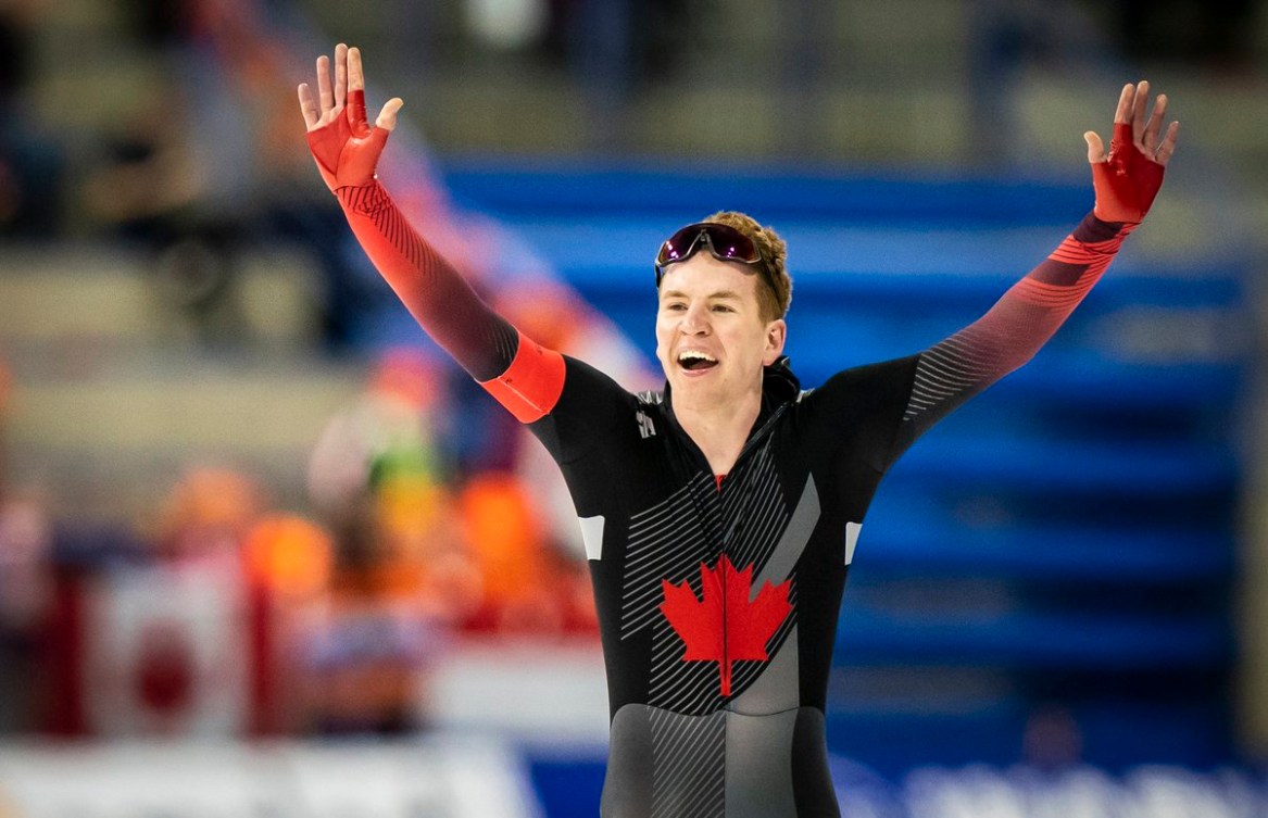 Speed skater celebrates a victory at the finish line