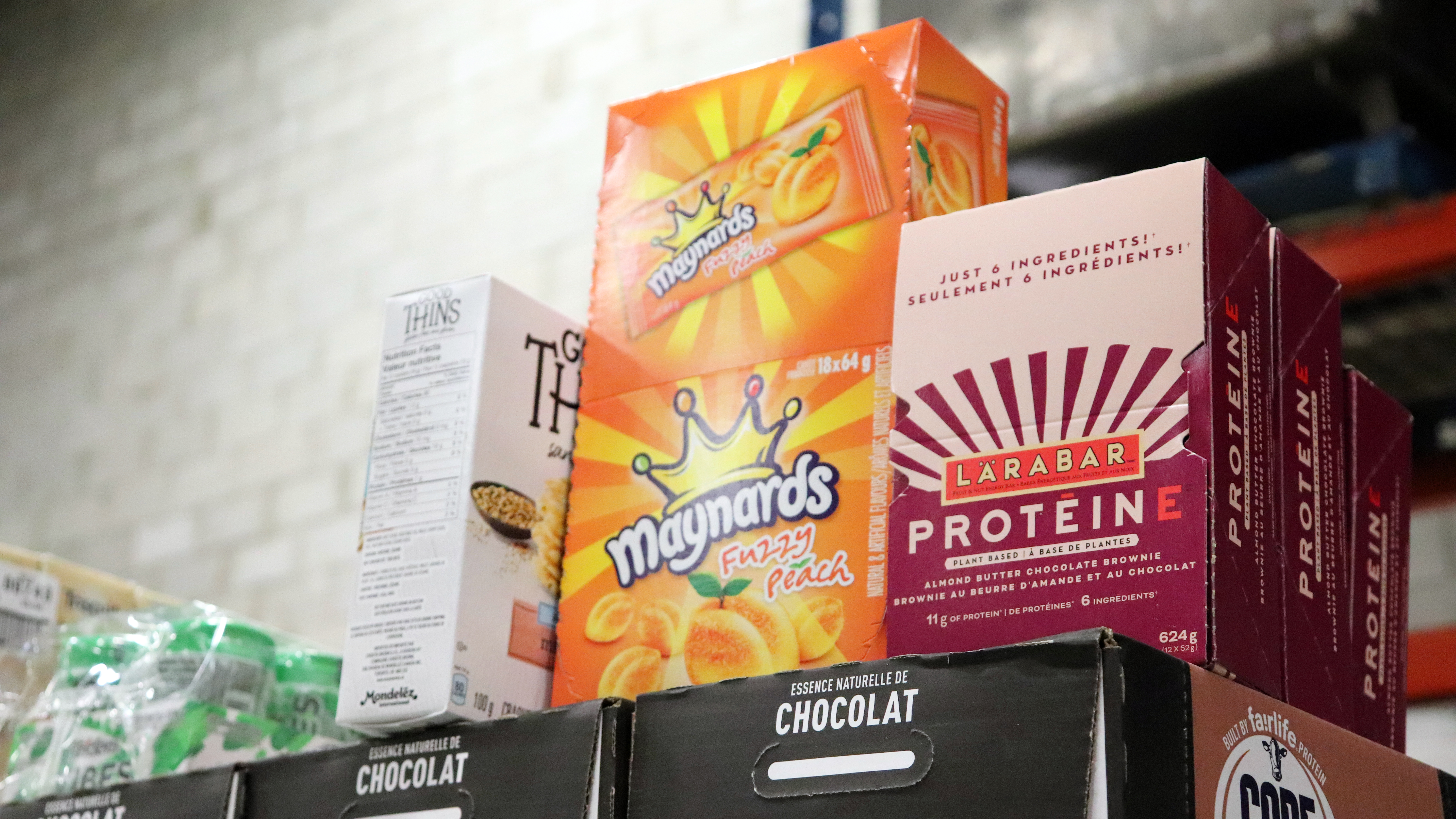Snacks to be donated to Moisson Montréal (L-R Box of God Things, box of Maynards Peach Fuzzies, Larabar protein bars.