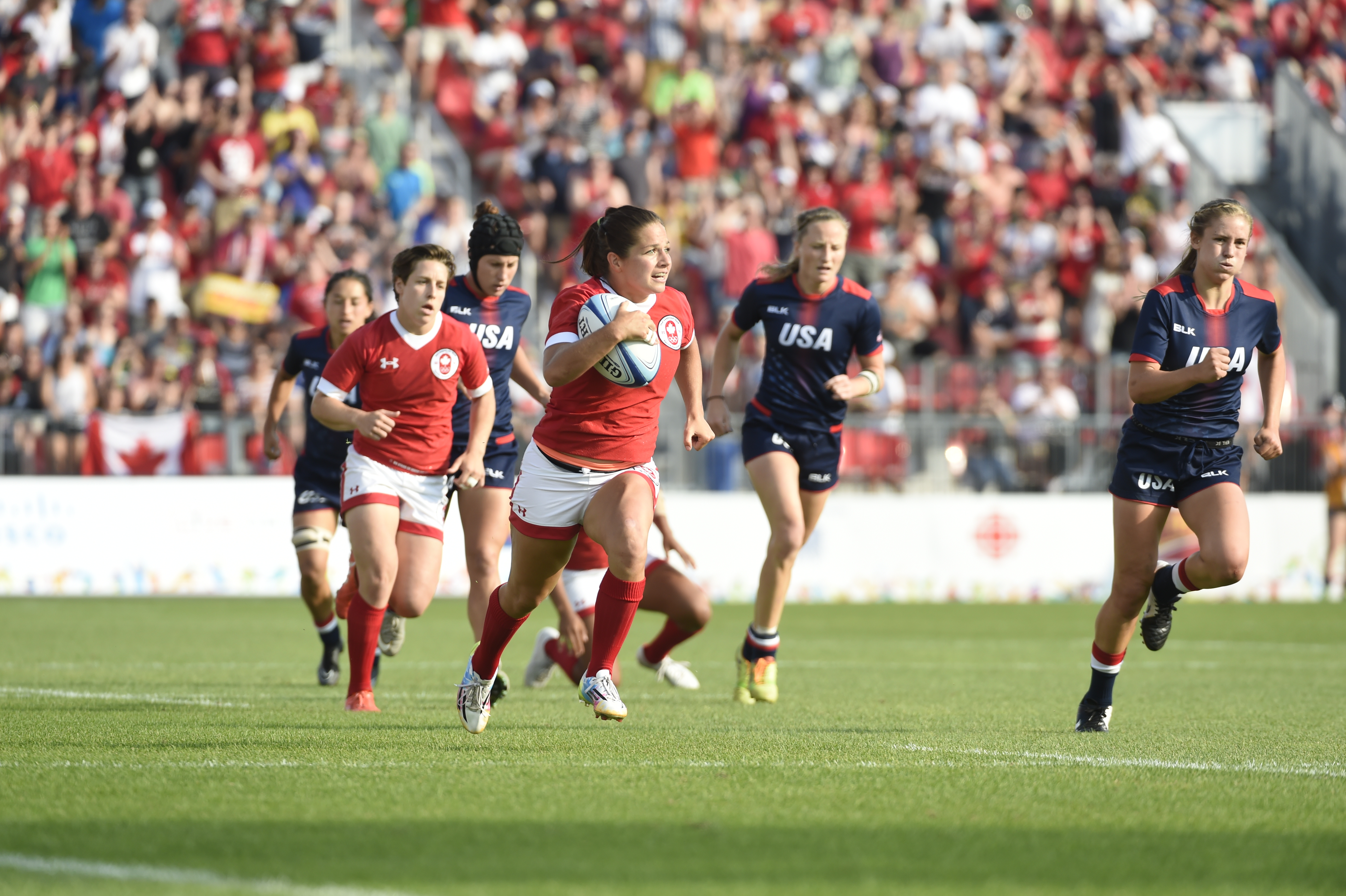 On field with Canadian running with ball