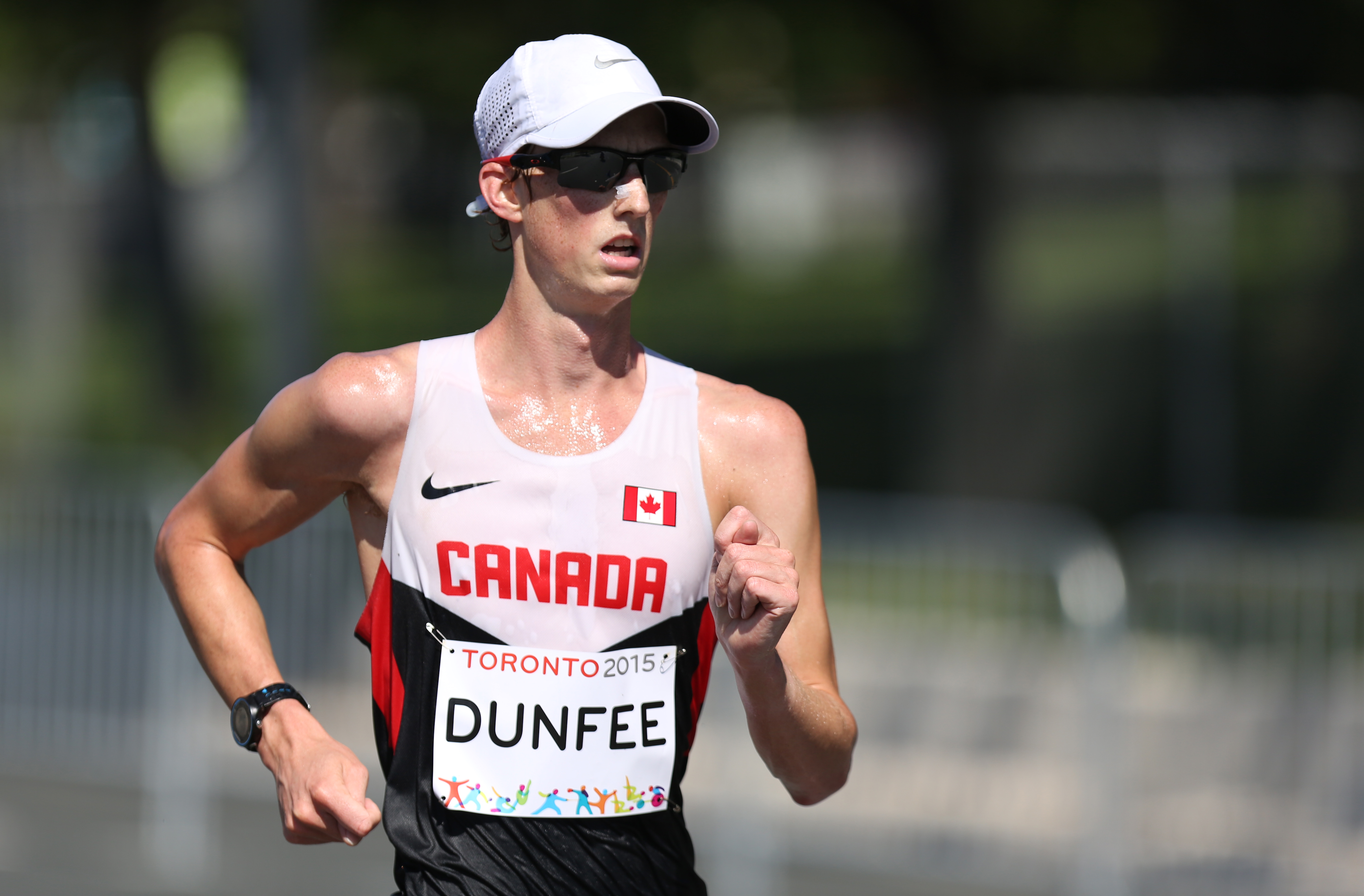 Dunfee in a racewalk with sunglasses and hat on