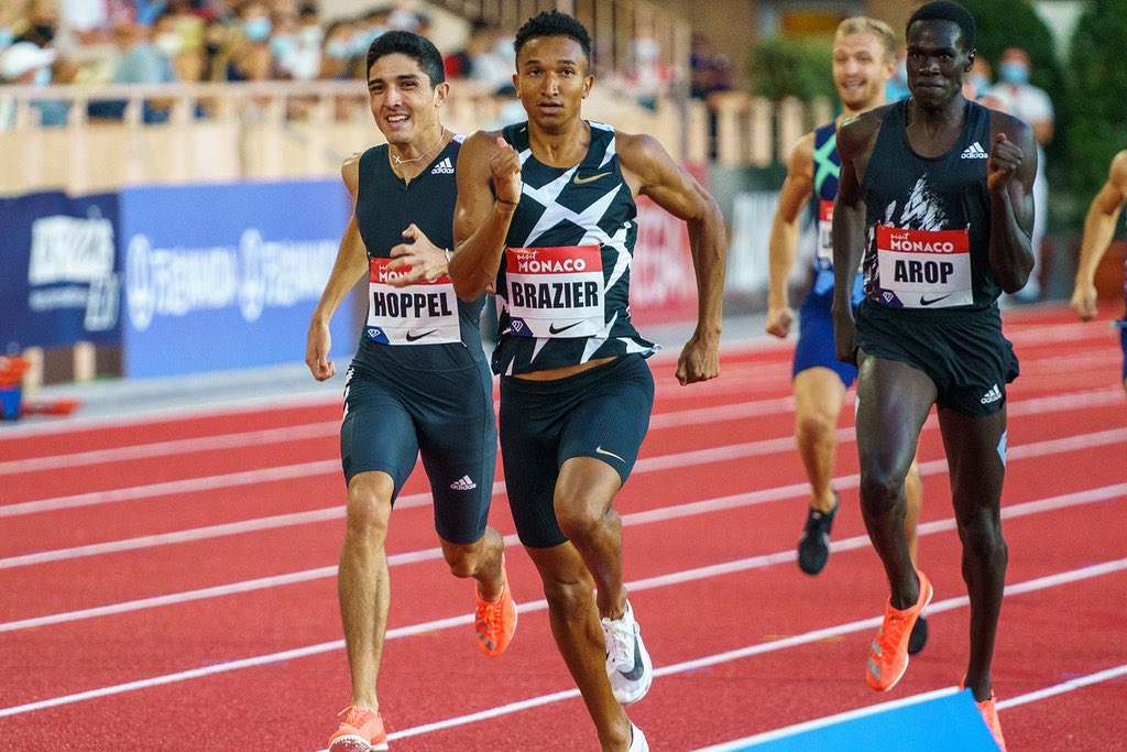 Marco Arop (right) runs behind the two leaders of the race.