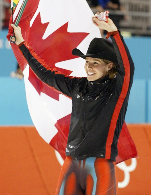 Catriona Le May Doan waves the Canadian flag in celebration