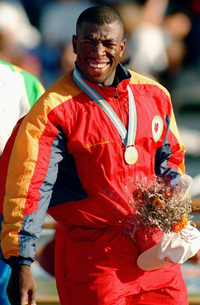 Gilbert, Glenroy Canada's Glenroy Gilbert celebrates the gold medal he won in the men's 100m at the 1995 Pan American Games in Mar Del Plata, Argentina. (CP Photo/COC/F. Scott Grant) Glenroy Gilbert du Canada célèbre sa médaille d'or au 100 m aux Jeux panaméricains de 1995 de Mar Del Plata, Argentine. (Photo PC/AOC)