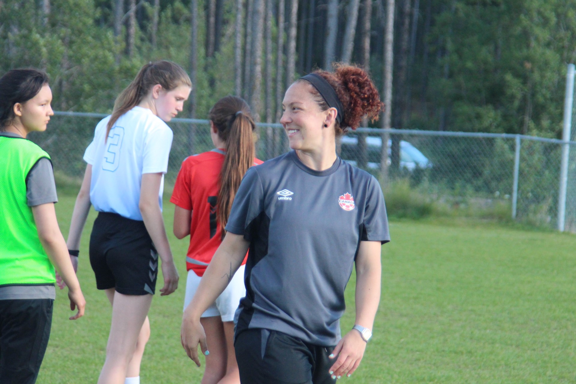 Soccer coach with young players 