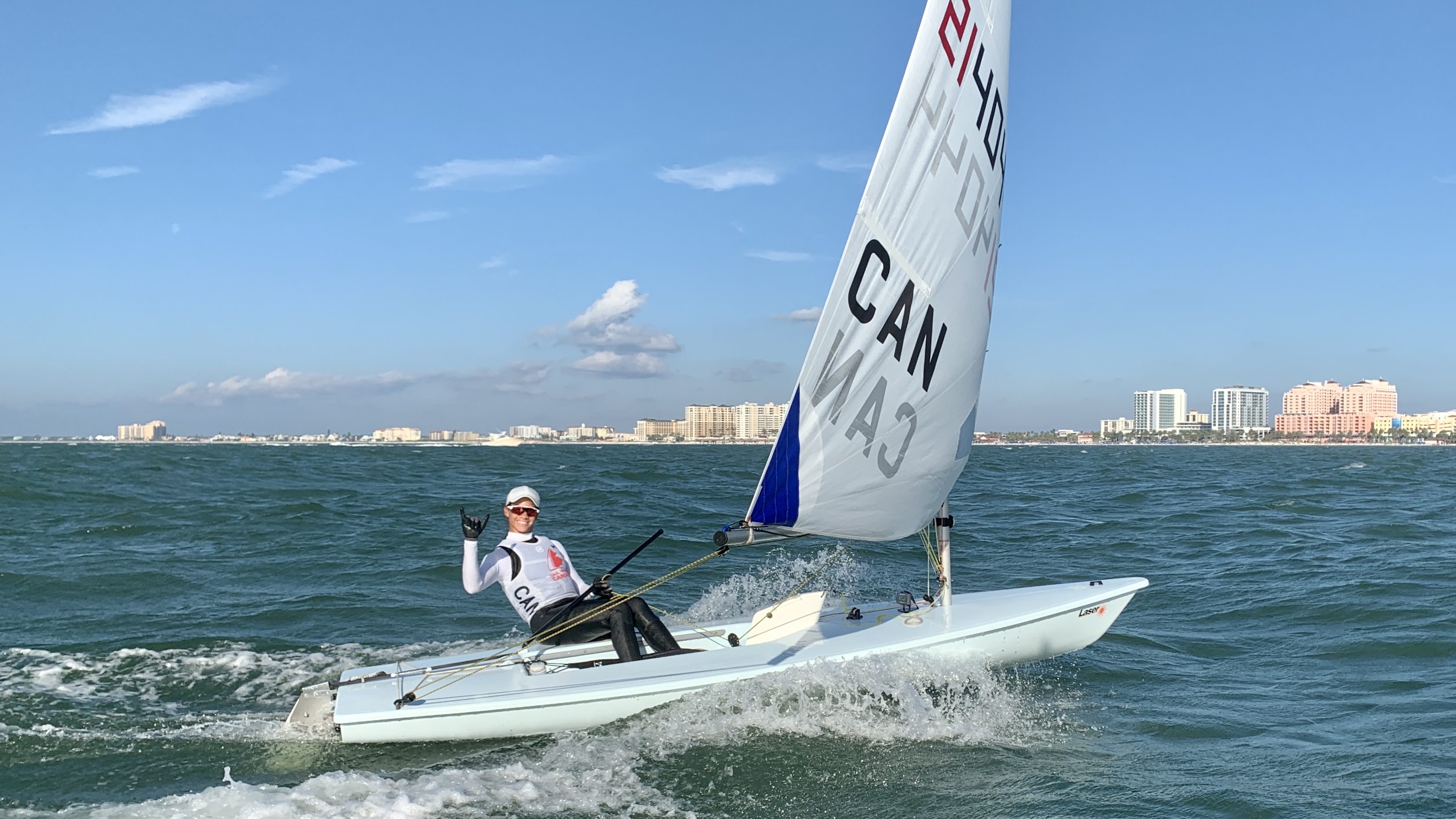 Sarah Douglas waves from her sailboat on the water