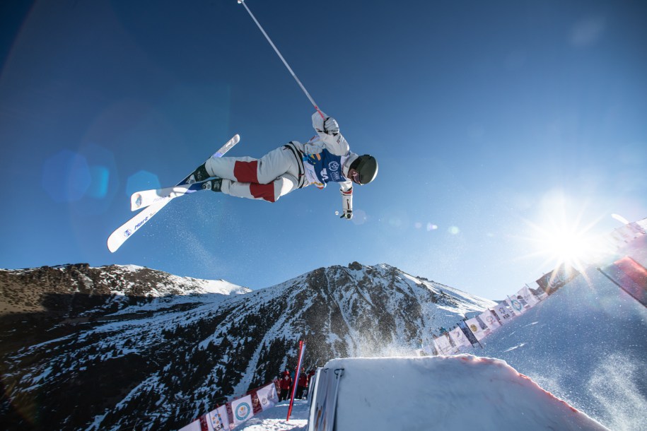 Jordan Kober mid-air during a moguls run.