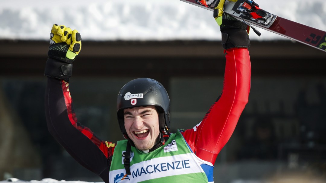 Skier celebrates with arms in air