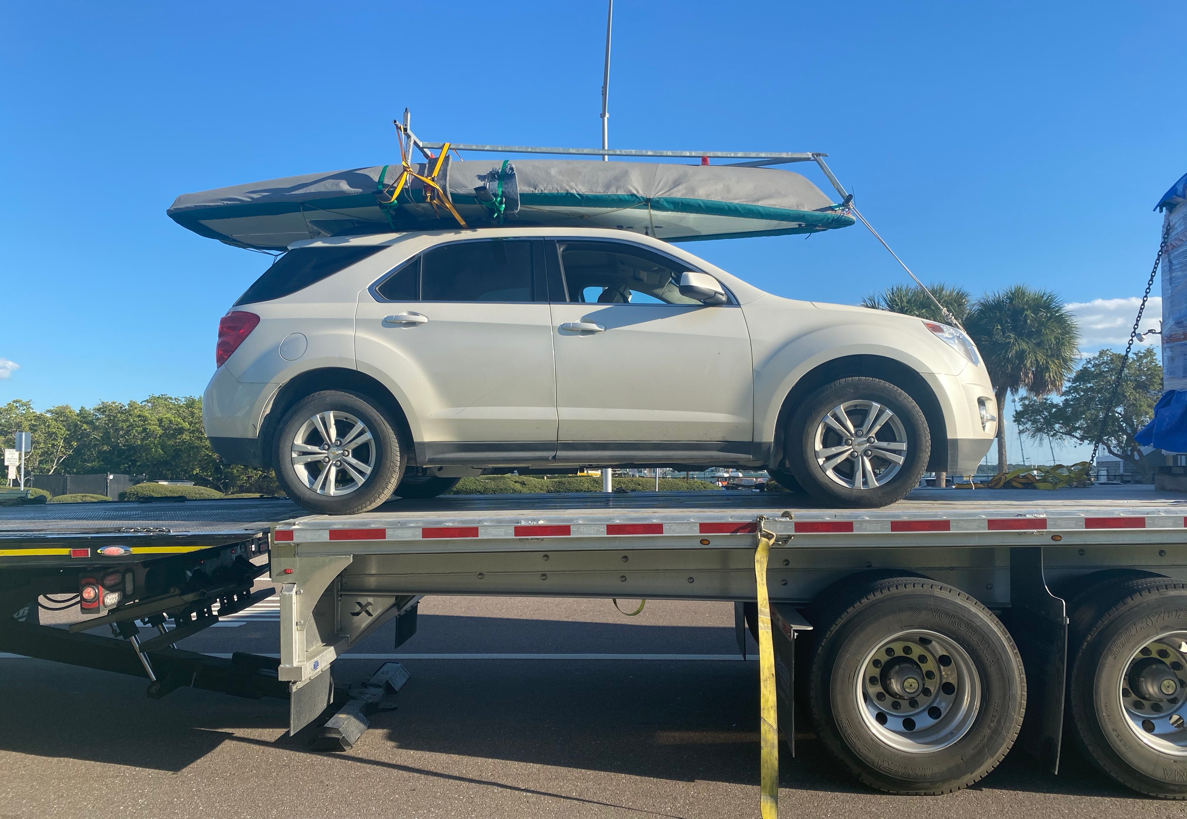 Car with boat on roof rack