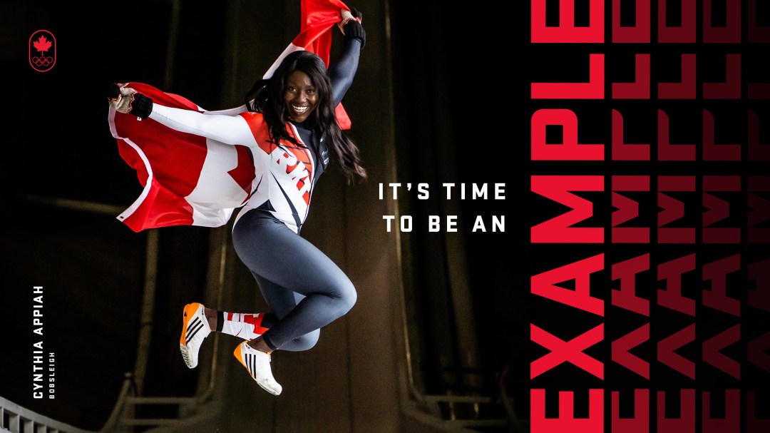 Bobsledder jumping with a Canadian flag