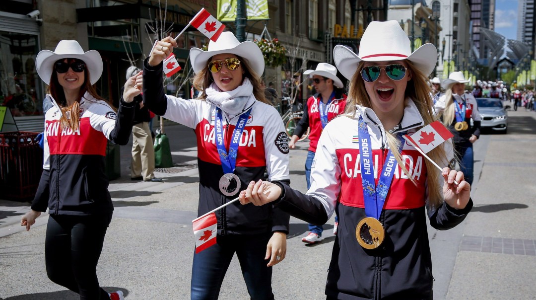 Sochi 2014 Olympians Justine Dufour-Lapointe, right, Chloe Dufour-Lapointe. centre, and Maxime Dufour-Lapointe, take part in a Parade of Champions in Calgary, Alta., Friday, June 6, 2014.